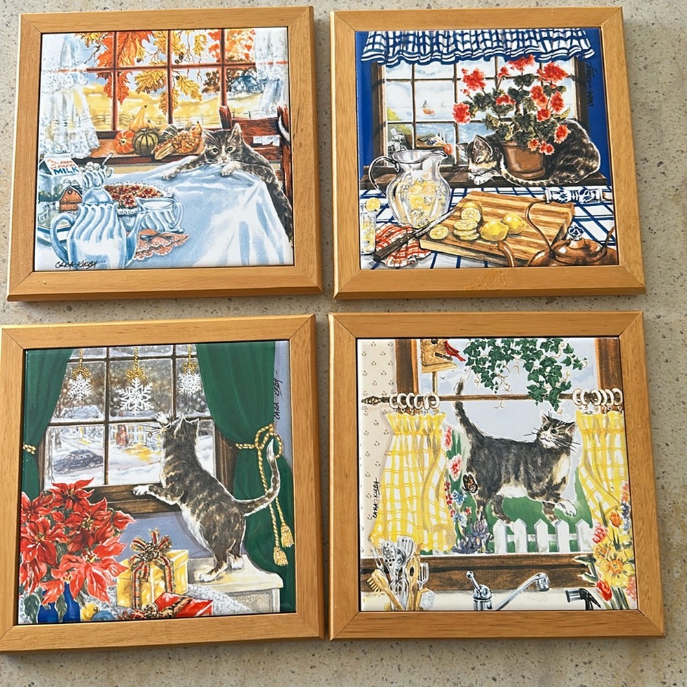 Four cat tile trivets or wall hangings.
